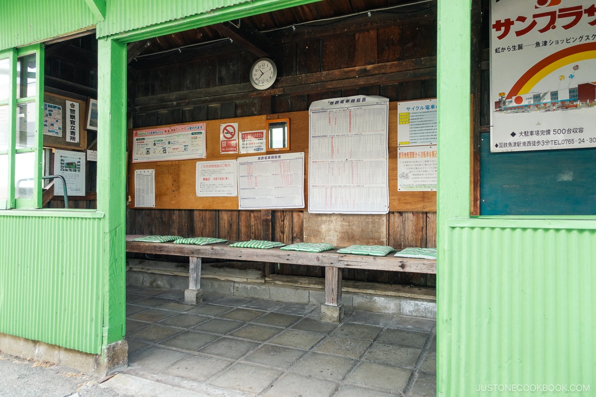 an old Japanese train station with seating area