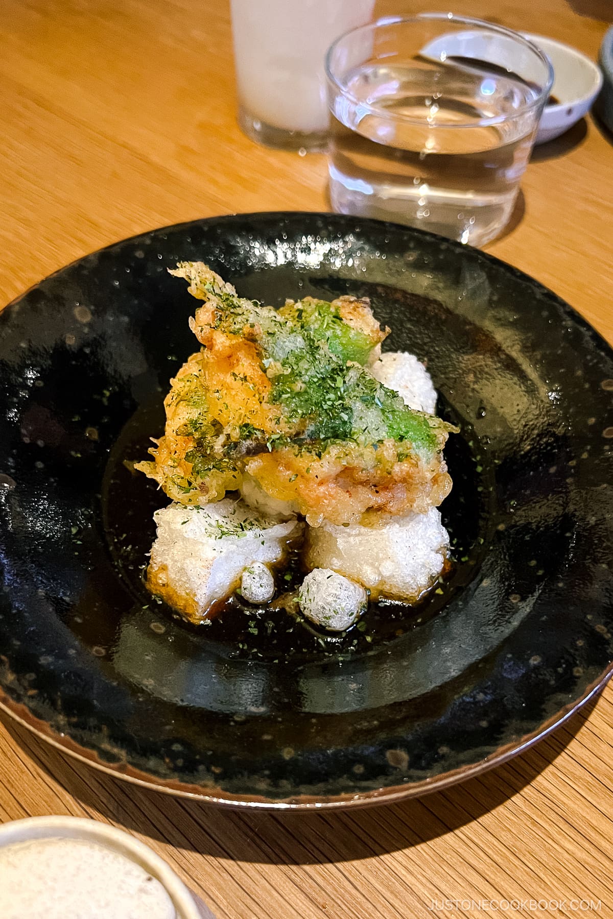 fried mochi on a black plate