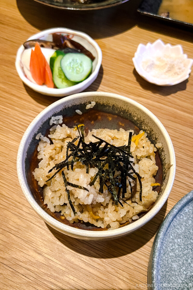 a bowl of mixed rice with nori on top