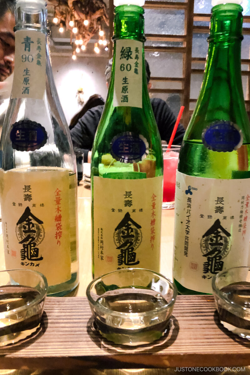 3 bottles of sake with 3 cups in front