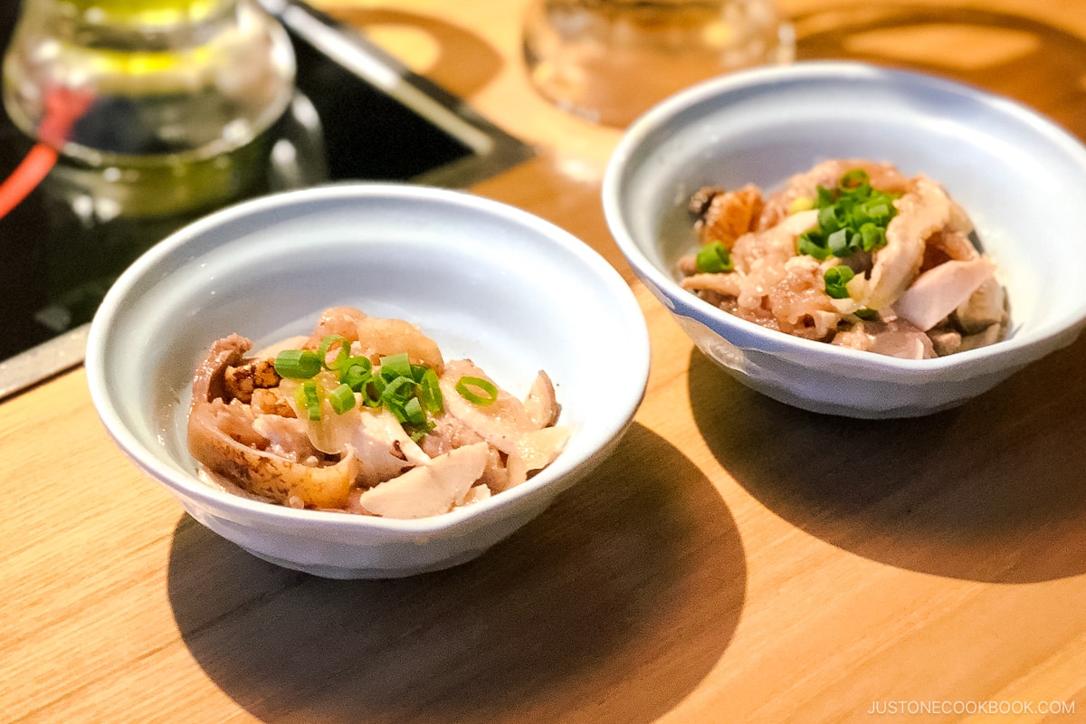 two bowls of appetizers in white bowls