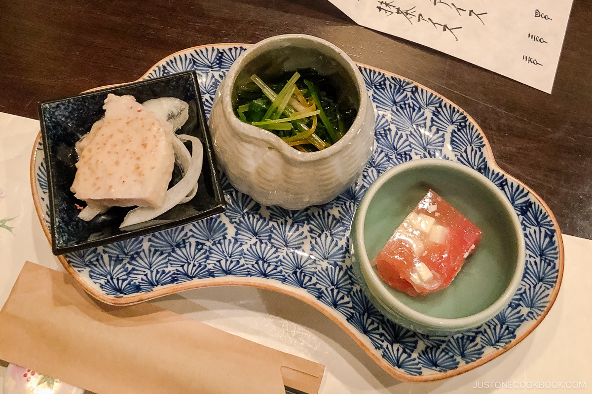 three small dishes on a blue dish