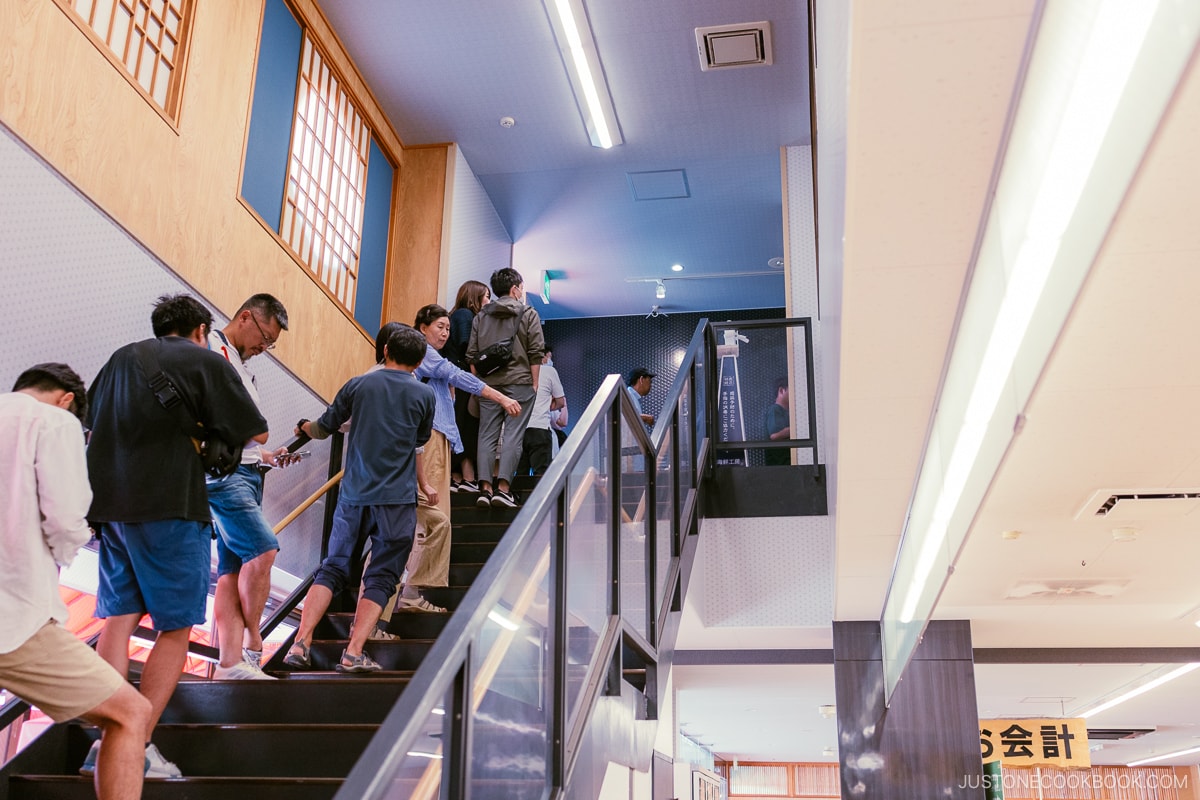 People lining up for the restaurant on steps