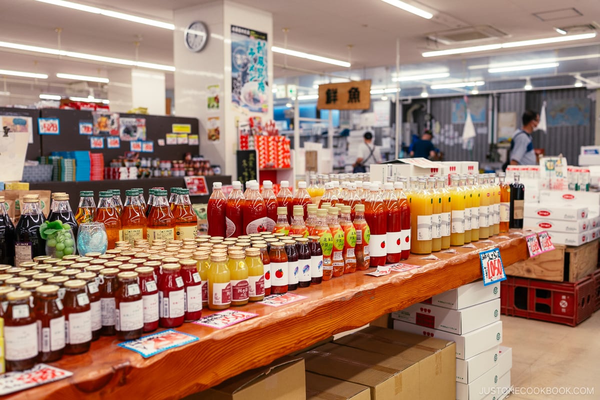 Locally made fruit and vegetable drinks for sale on wood table