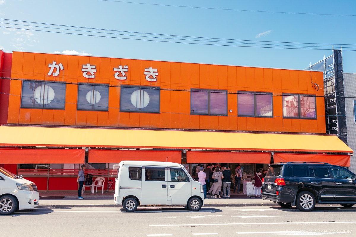 Exterior of Kakizaki Shoten building with people lining up outside