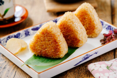 A rectangular plate containing Yaki Onigiri (Grilled Rice Balls).