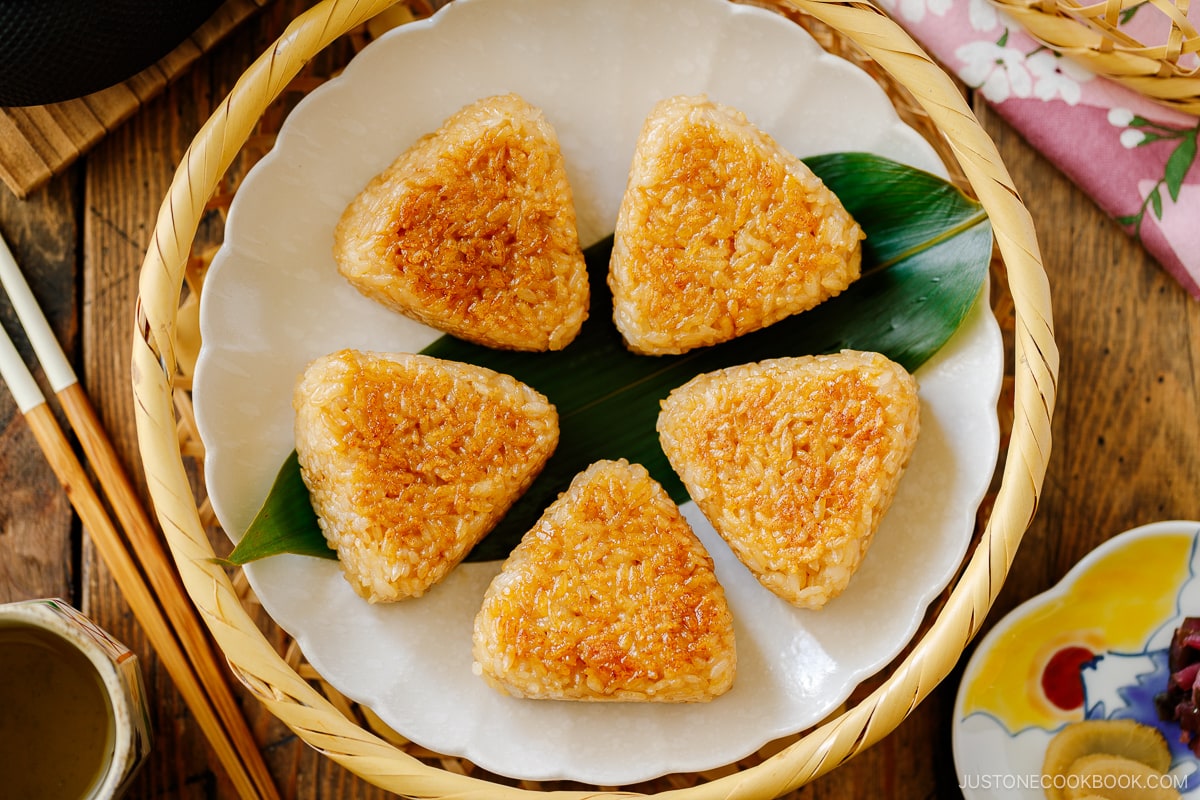 A white fluted plate containing Yaki Onigiri (Grilled Rice Balls).