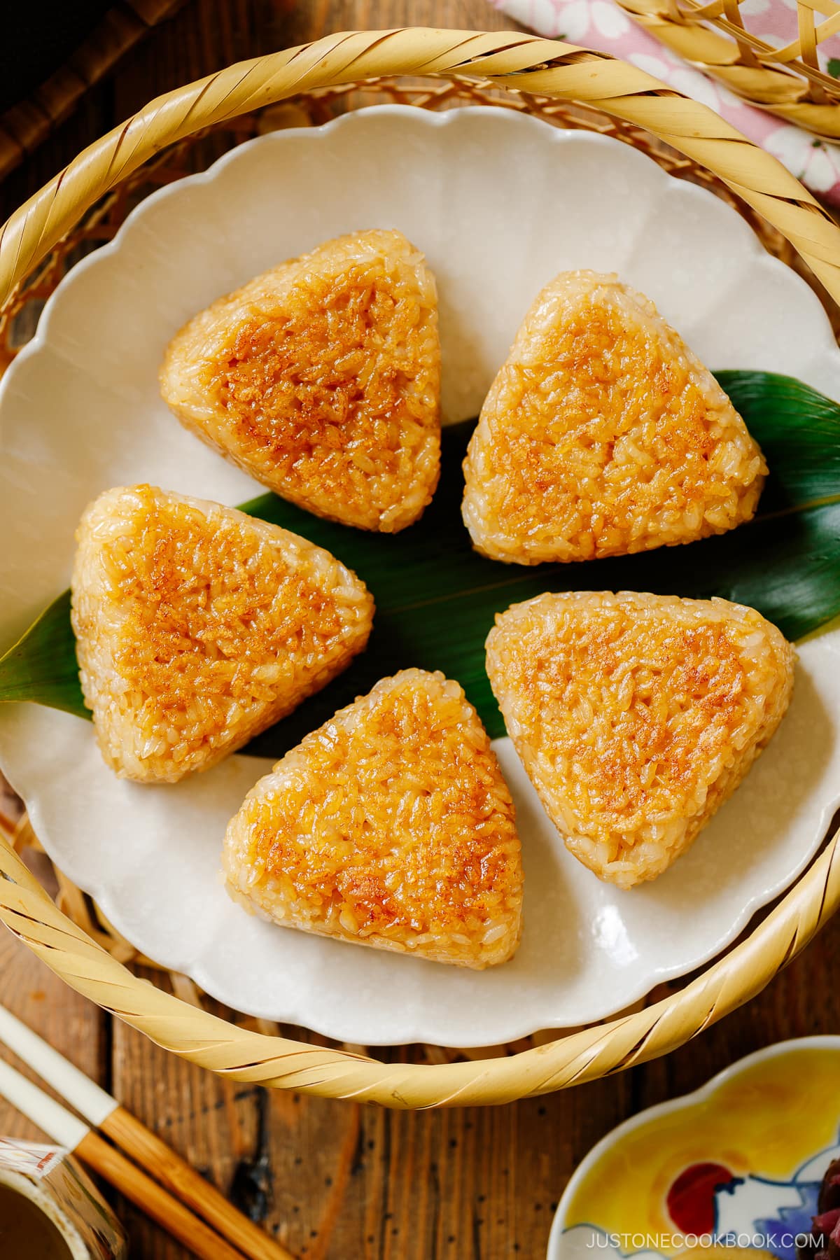 A white fluted plate containing Yaki Onigiri (Grilled Rice Balls).