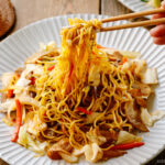 A fluted plate containing Yakisoba (Japanese Stir-Fried Noodles).