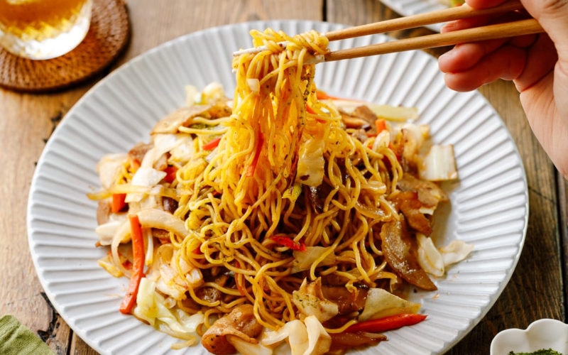 A fluted plate containing Yakisoba (Japanese Stir-Fried Noodles).