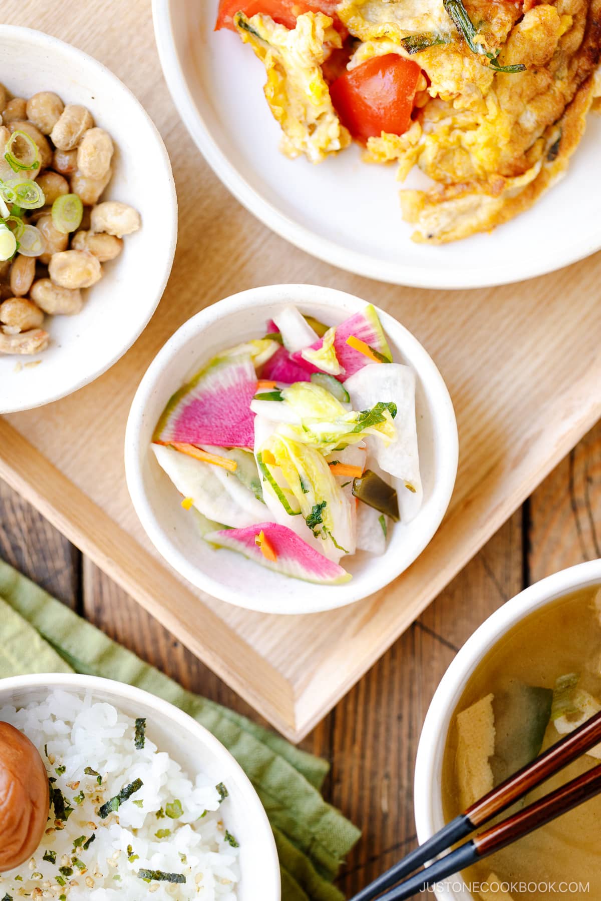 A white small dish containing colorful Japanese Pickles.