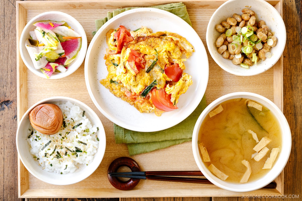 A white small dish containing colorful Japanese Pickles, served with Japanese-style meal set.