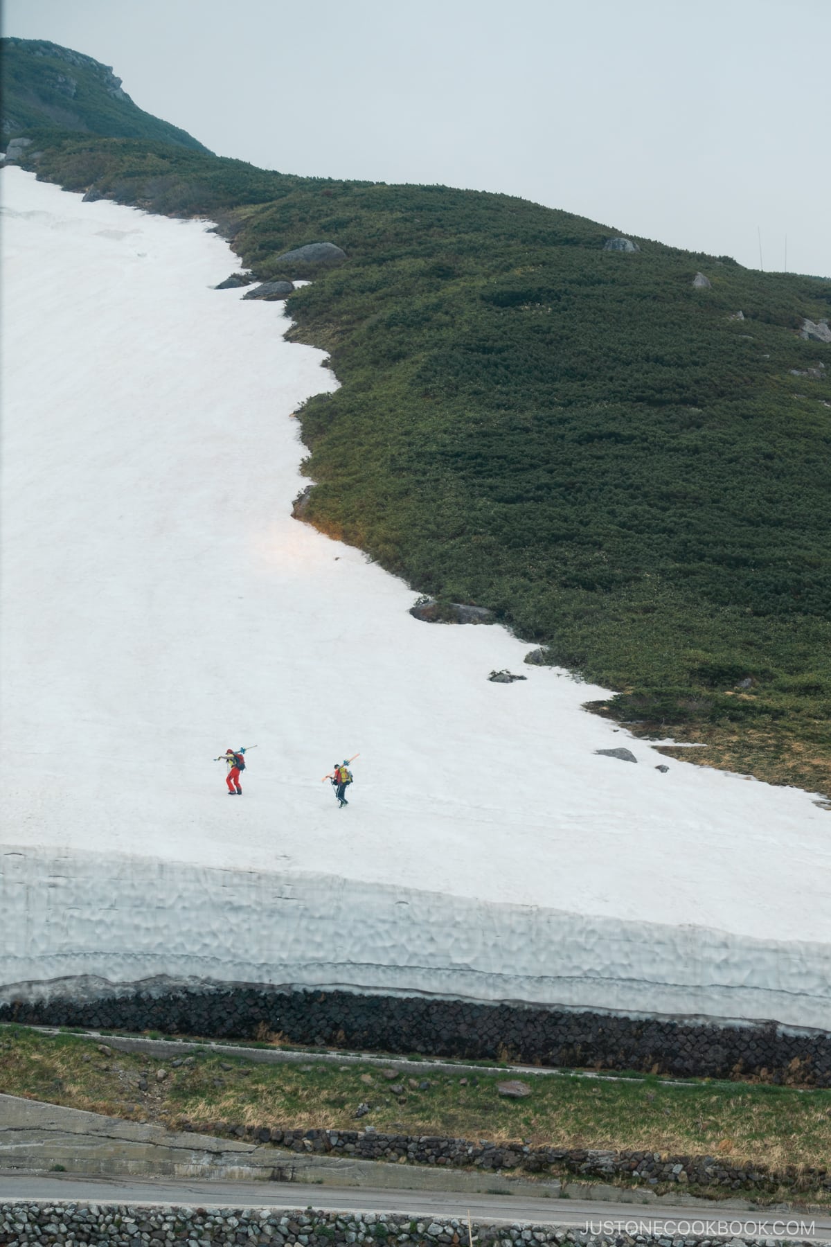 Snow hikers walking up the mountain in Murodo