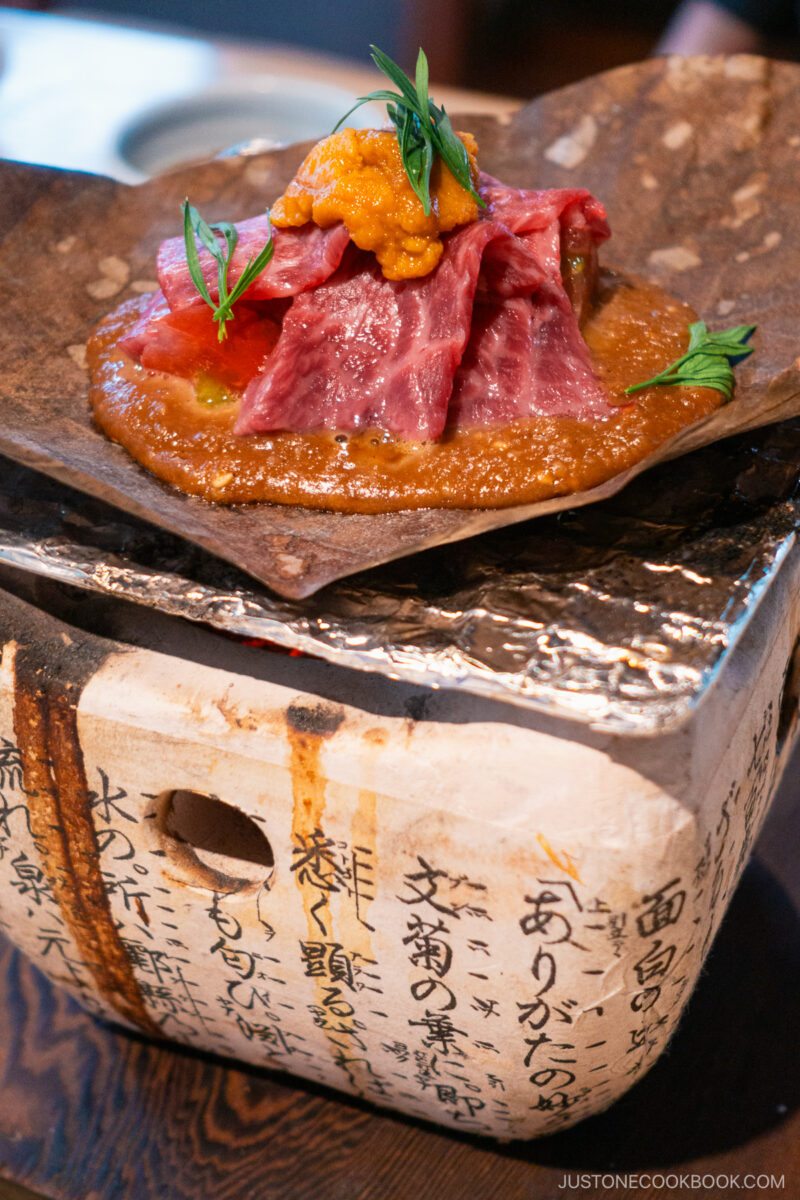 Izakaya Dai Hida beef with sea urchin, grilled on Magnolia leaf