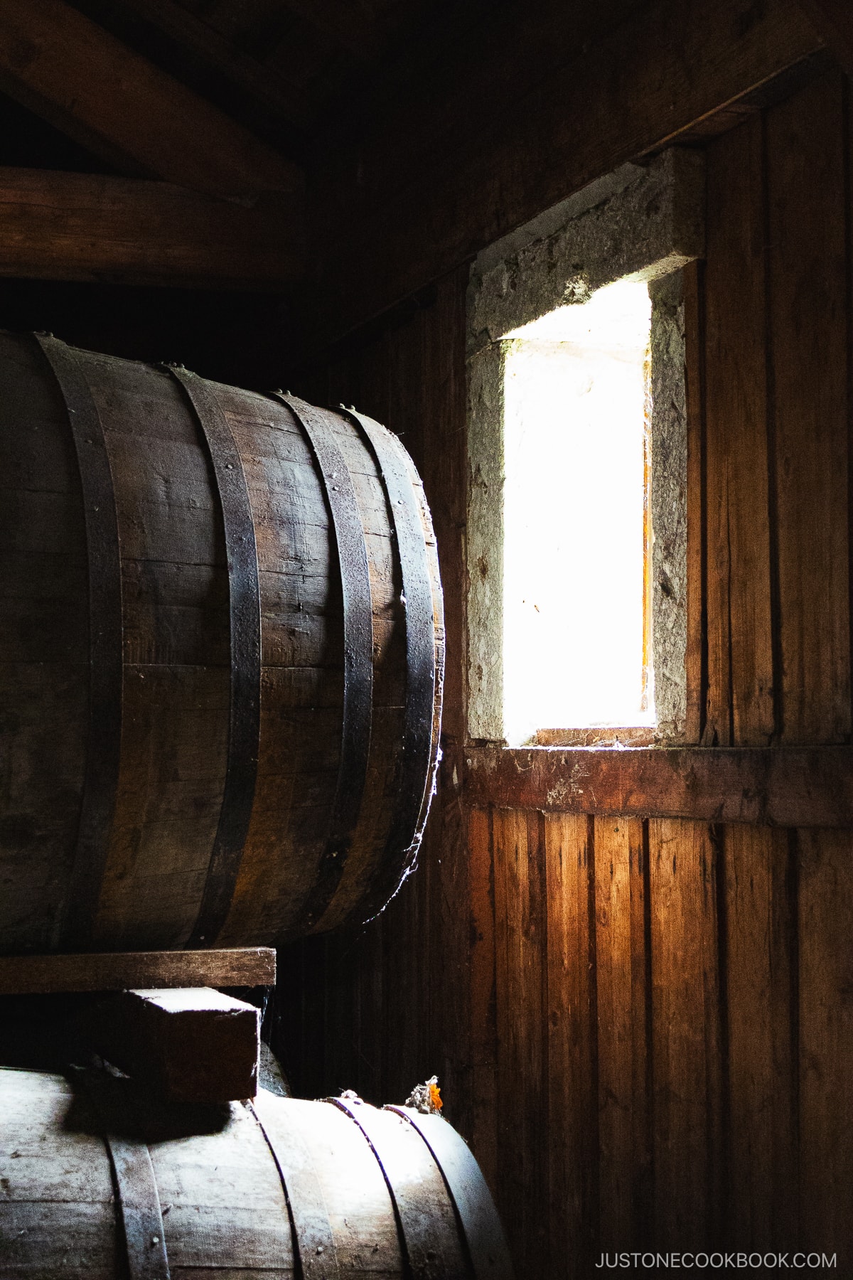 Whisky Kegs stored in a warehouse in front of a window