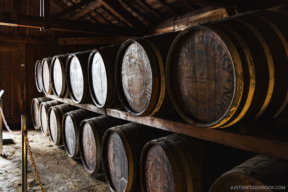 Whisky kegs stored in a warehouse in front of a window