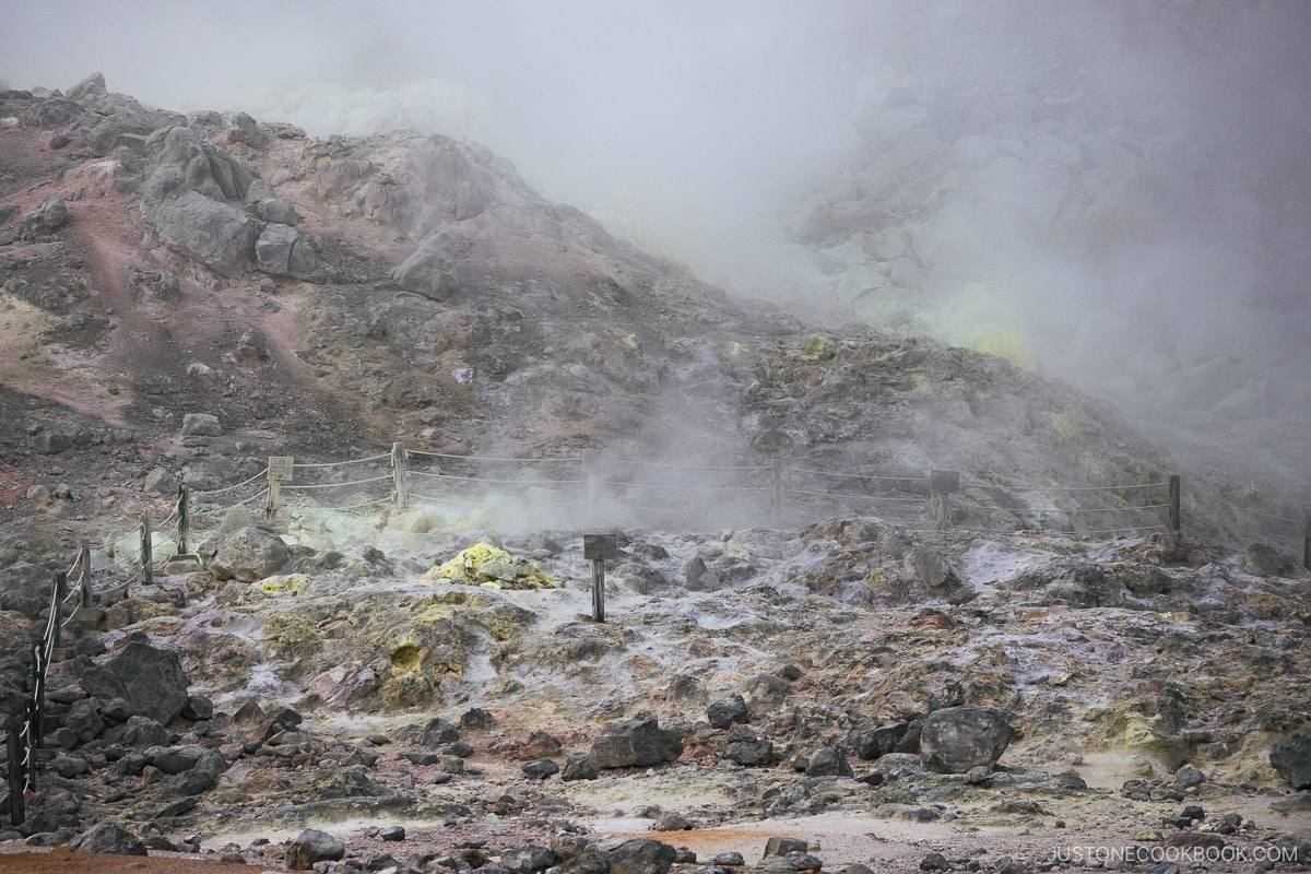 Mt Io sign and sulfur rising from the ground