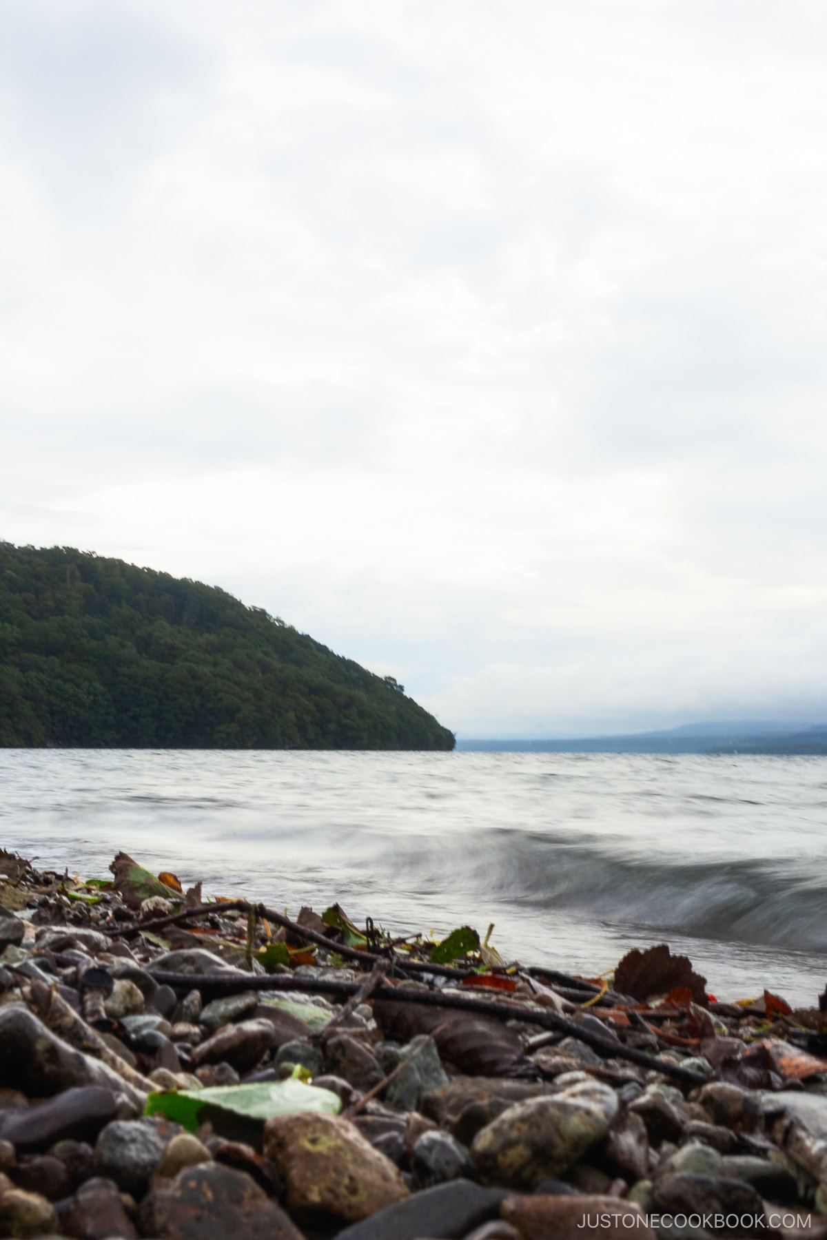 Lake kussharo with stone beach in the foreground