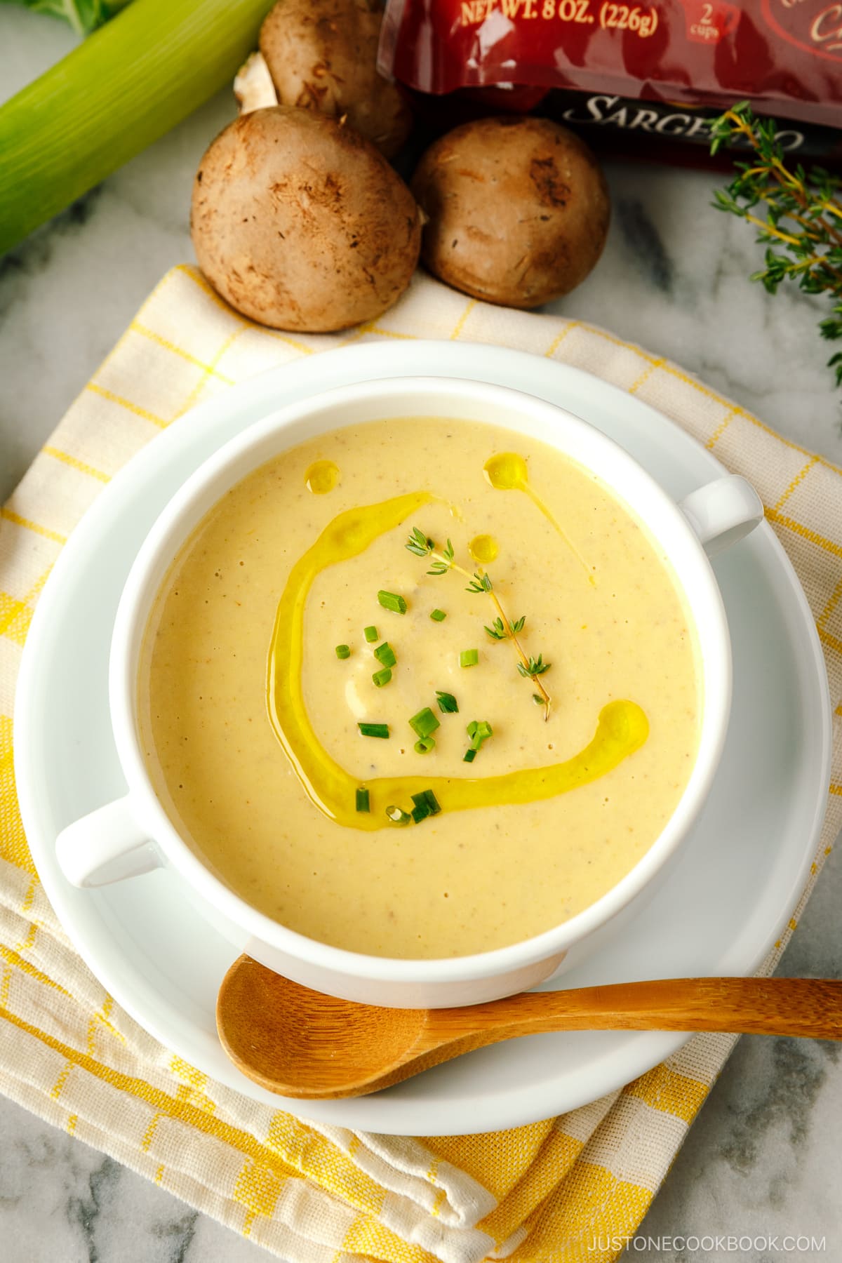 A white soup bowl containing Creamy Roasted Cauliflower Soup.