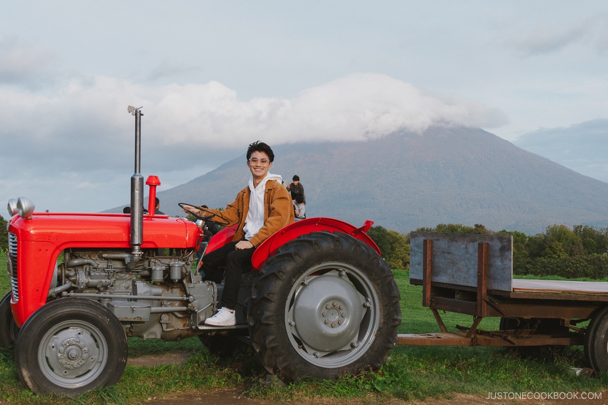 Sitting on a tractor in front of Mt Yotei