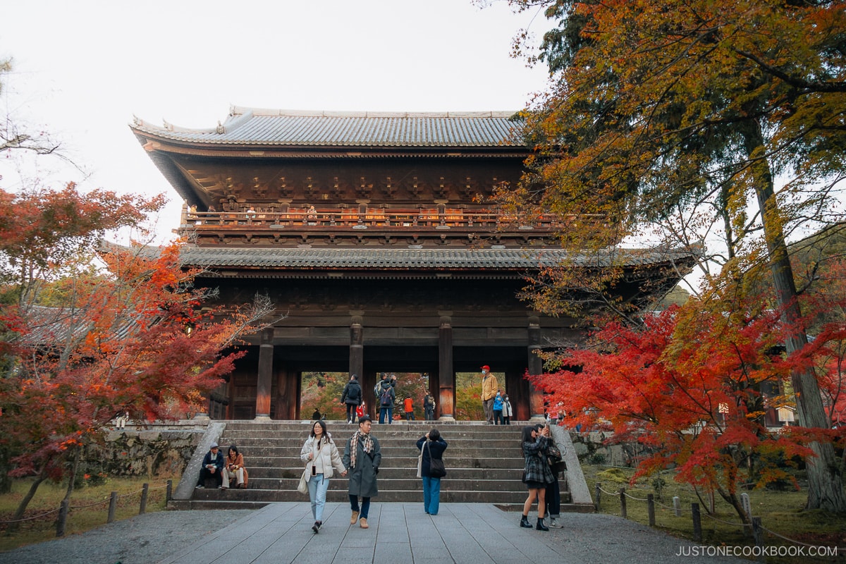 Smaller shrine entrance covered in colorful autumn leaves