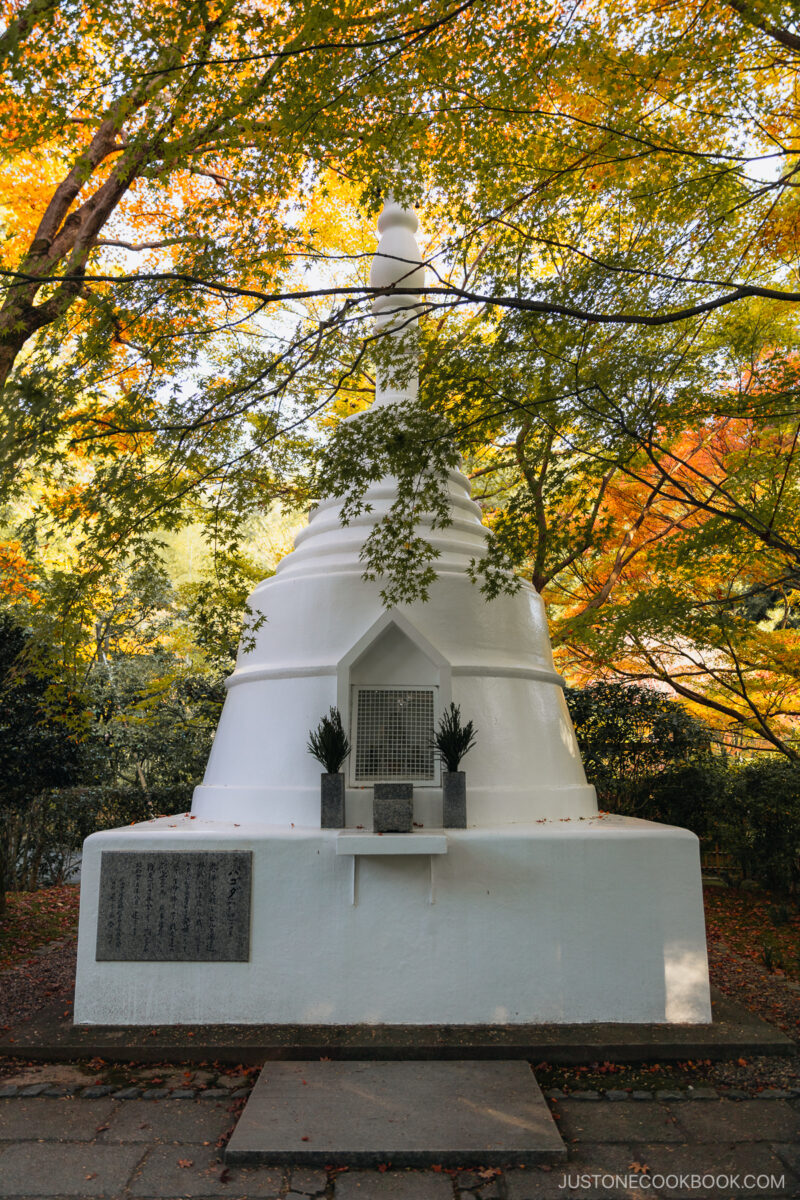 White shrine under yellow autumn leaves