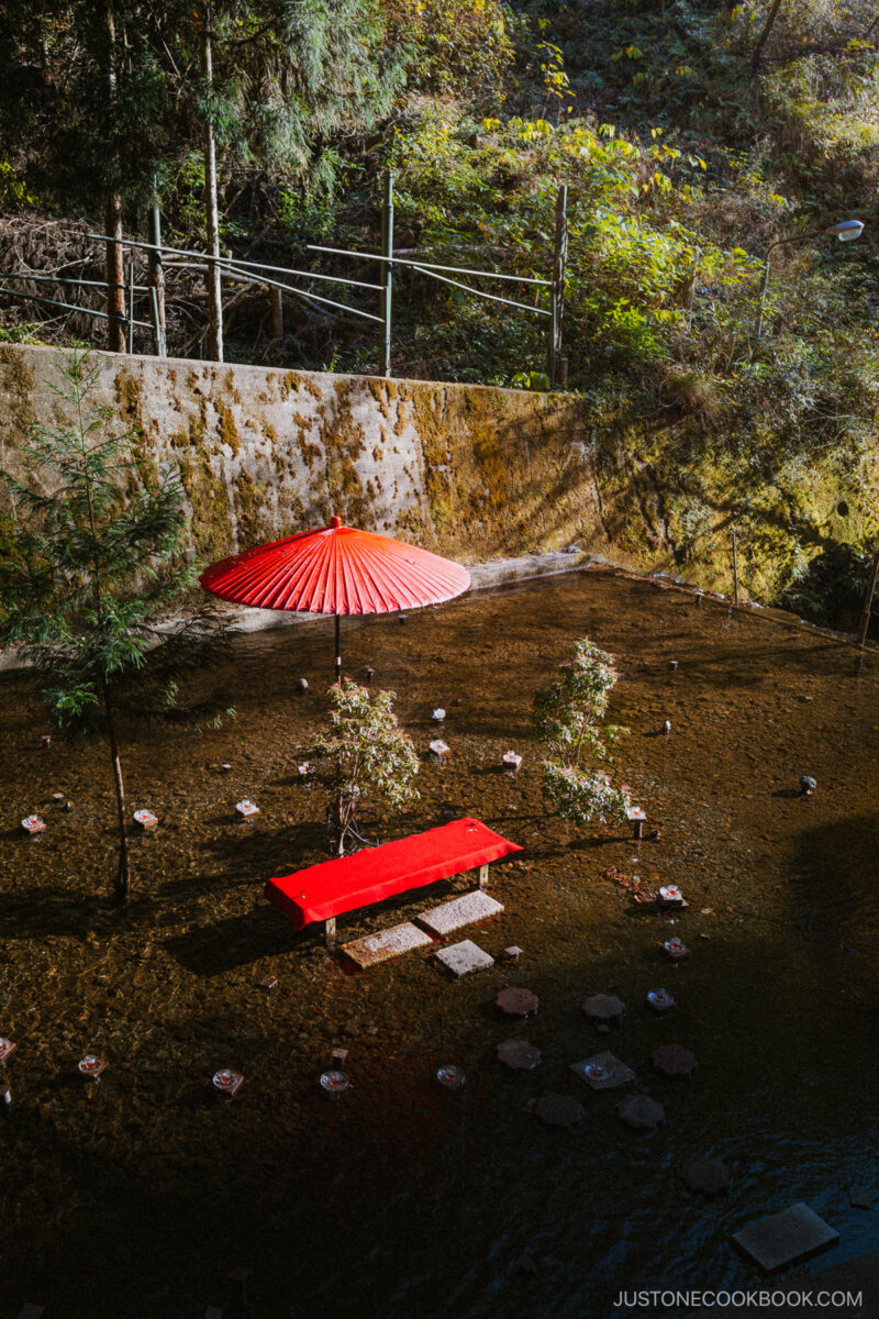 Red umbrella and seating area on the river