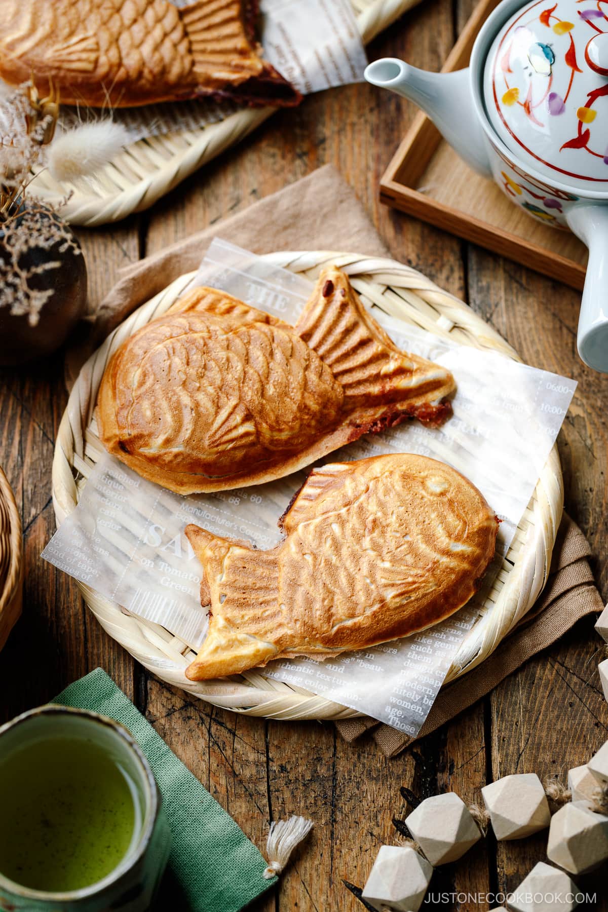 Taiyaki, Japanese fish-shaped cakes, placed on a woven basket lined with a parchment paper.