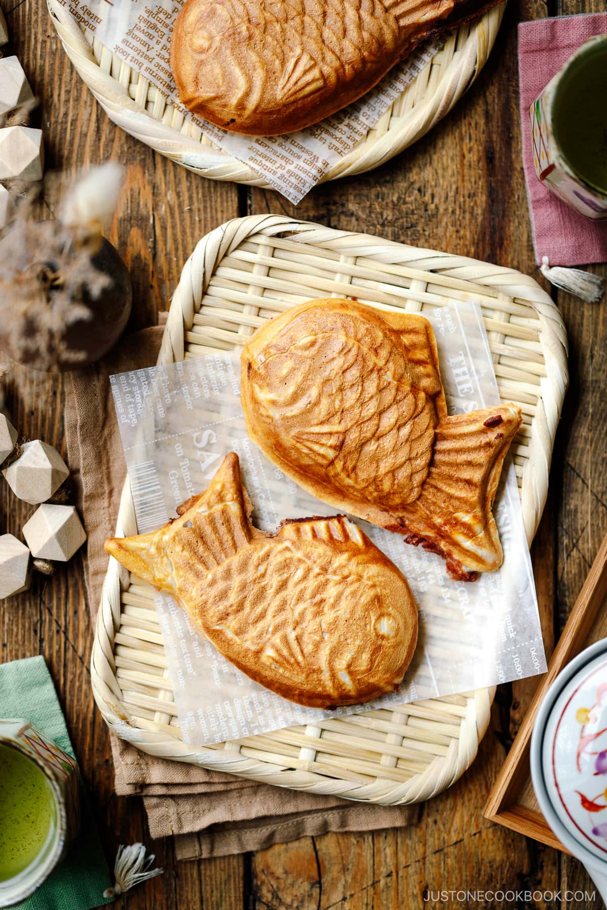 Taiyaki, Japanese fish-shaped cakes, placed on a woven basket lined with a parchment paper.