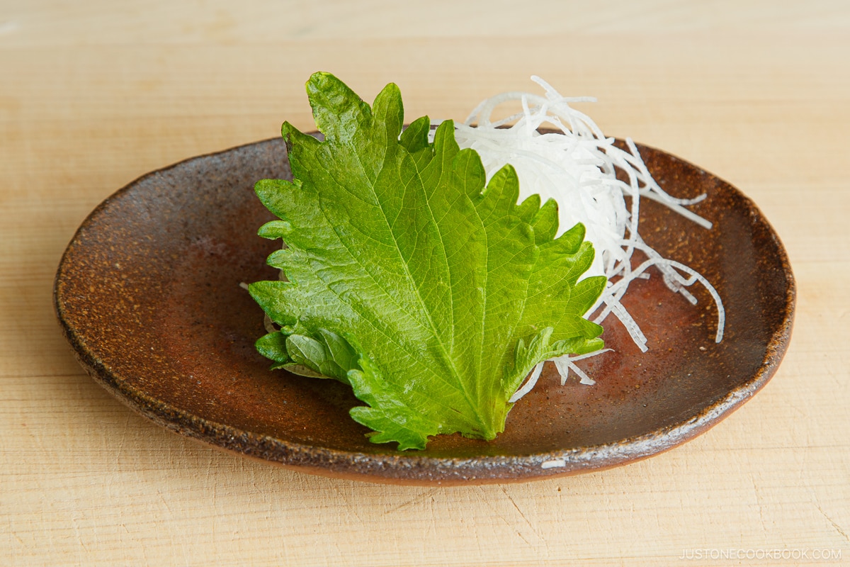 Daikon and shiso leaf garnish for plating sashimi.