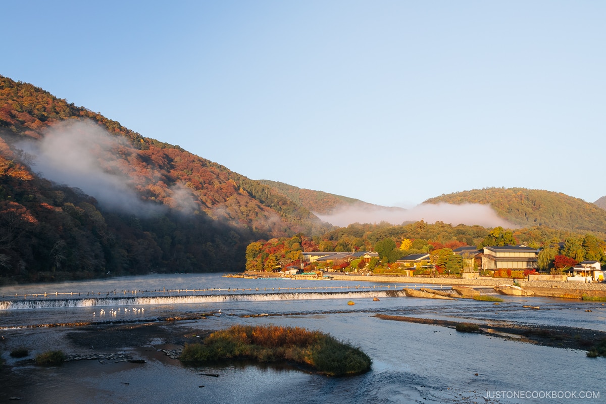 Arashiyama mountains covered with colorful autumn leaves at dawn