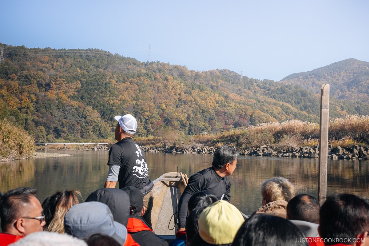 View from a wooden boat on the river with moutains in the background