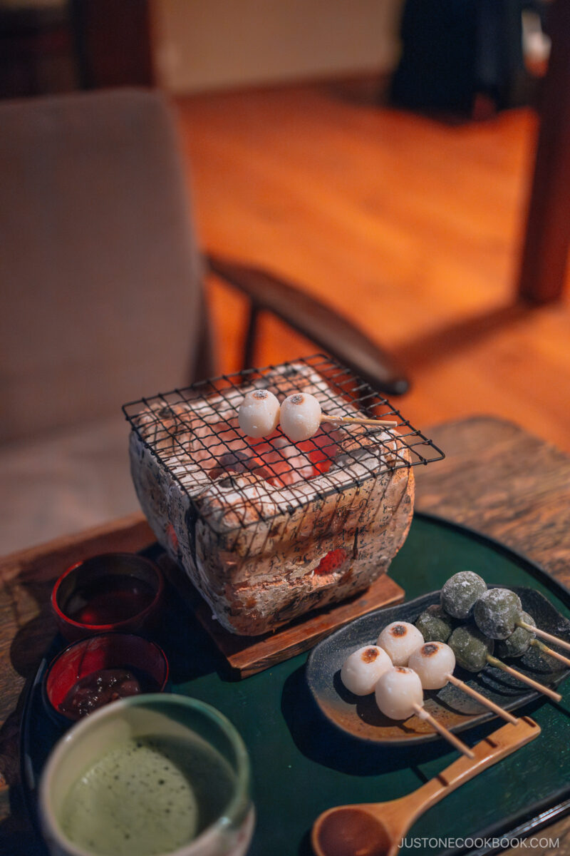 Grilling dango over charcoal