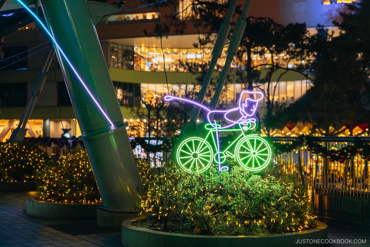 Illuminated character riding a bicycle