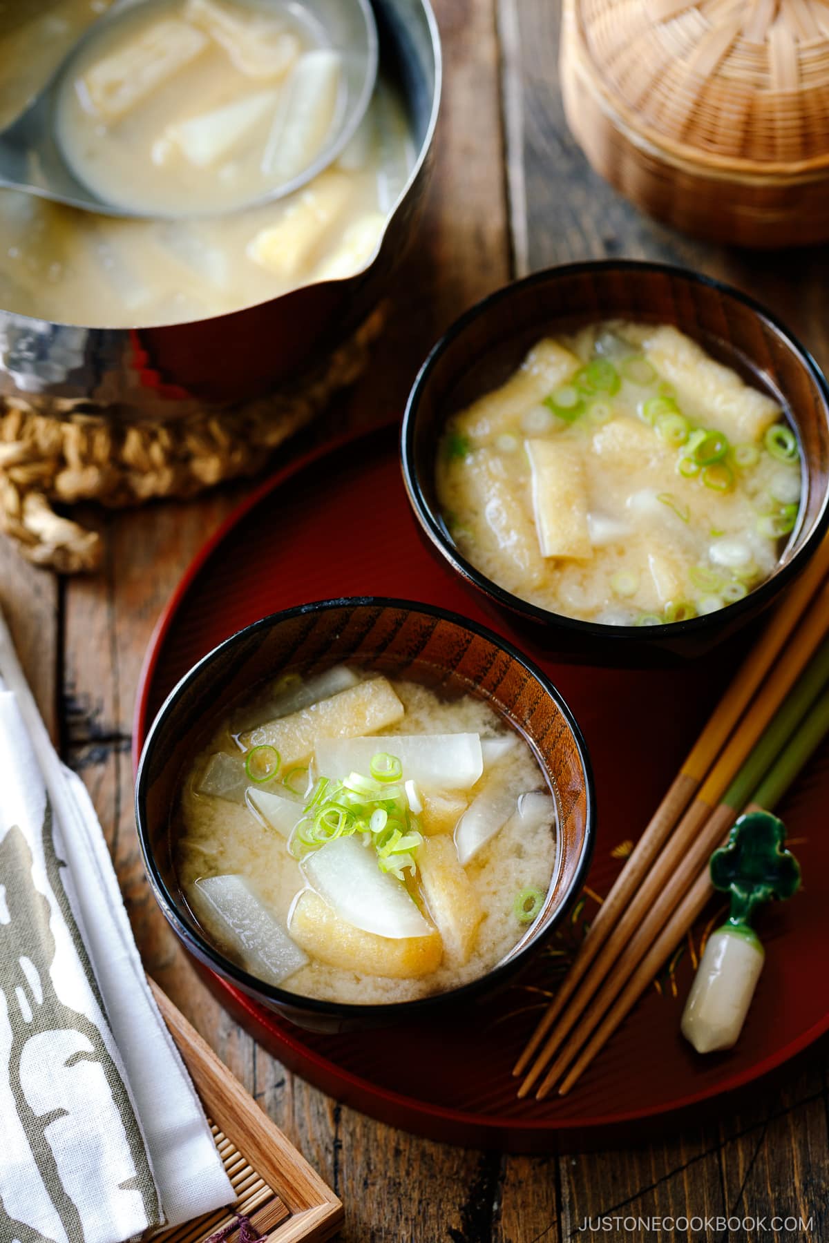 Japanese wooden soup bowls containing Daikon and Fried Miso Soup.