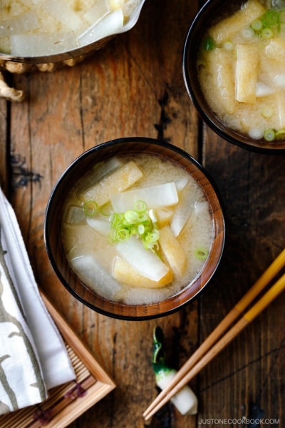 Japanese wooden soup bowls containing Daikon and Fried Miso Soup.