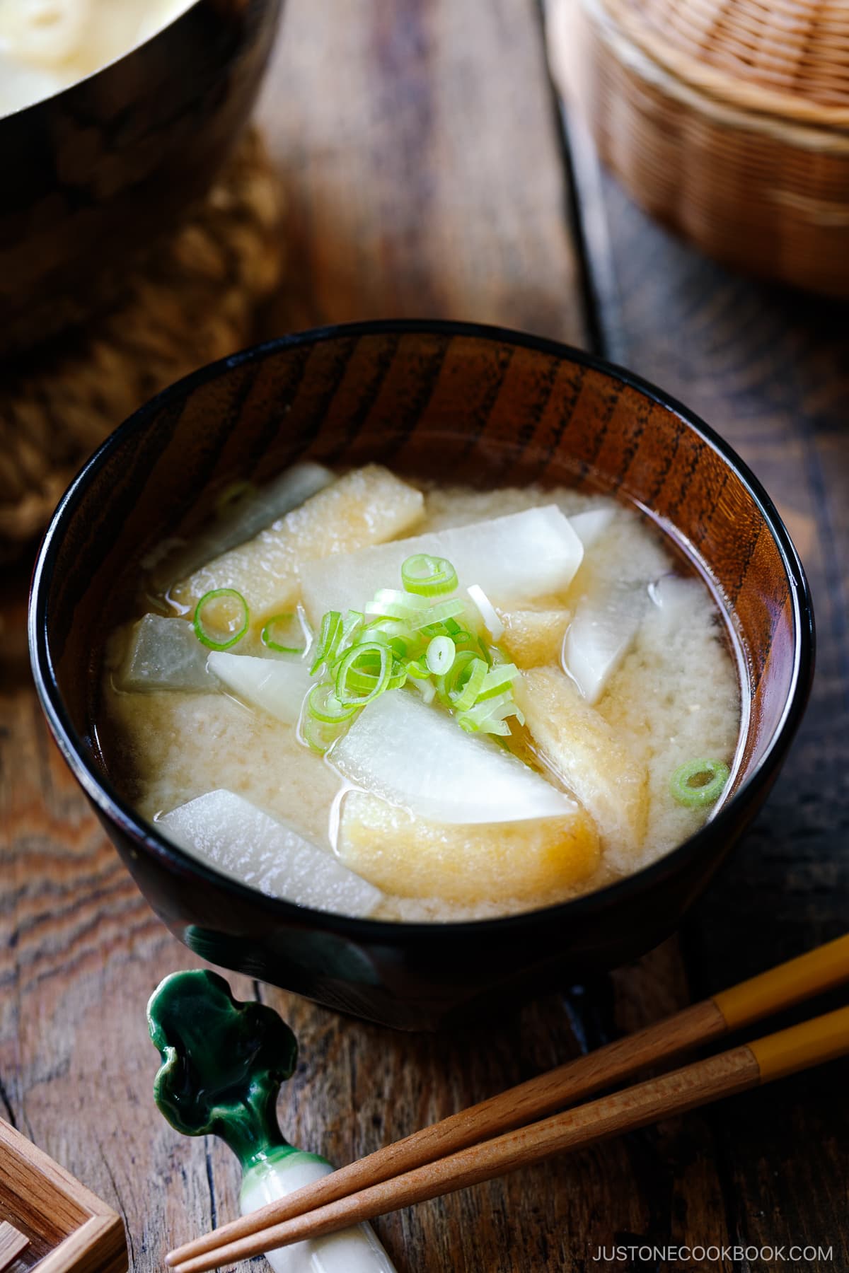 Japanese wooden soup bowls containing Daikon and Fried Miso Soup.