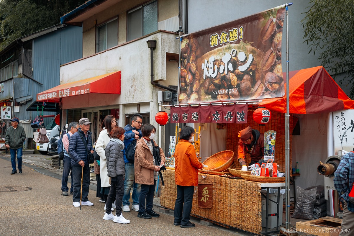 People lining up for a stall selling roasted chestnuts