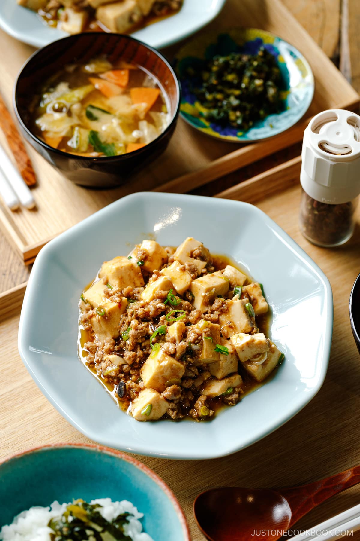 A ichiju sansai meal consists of steamed rice, miso soup, and mapo tofu.