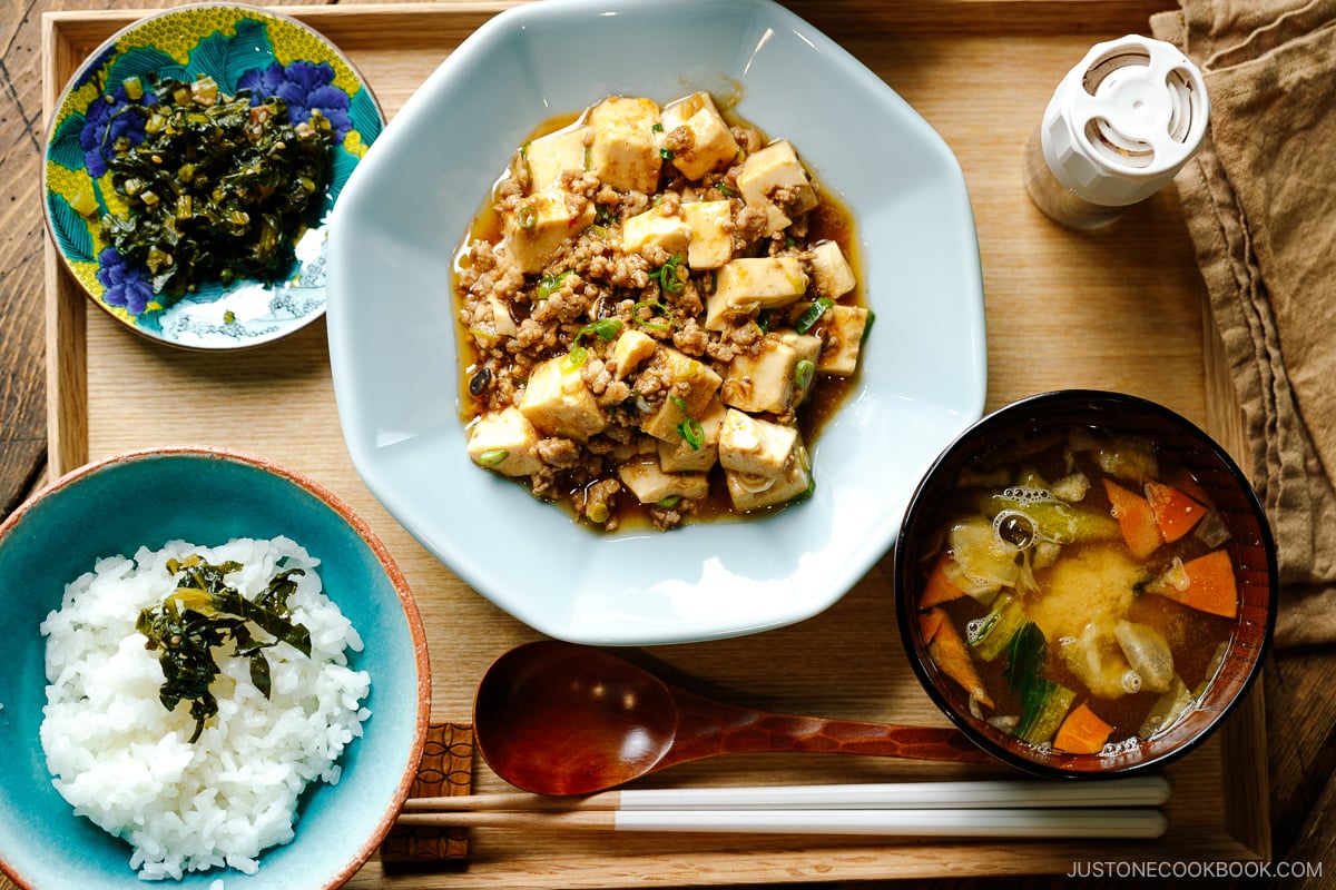 A ichiju sansai meal consists of steamed rice, miso soup, and mapo tofu.