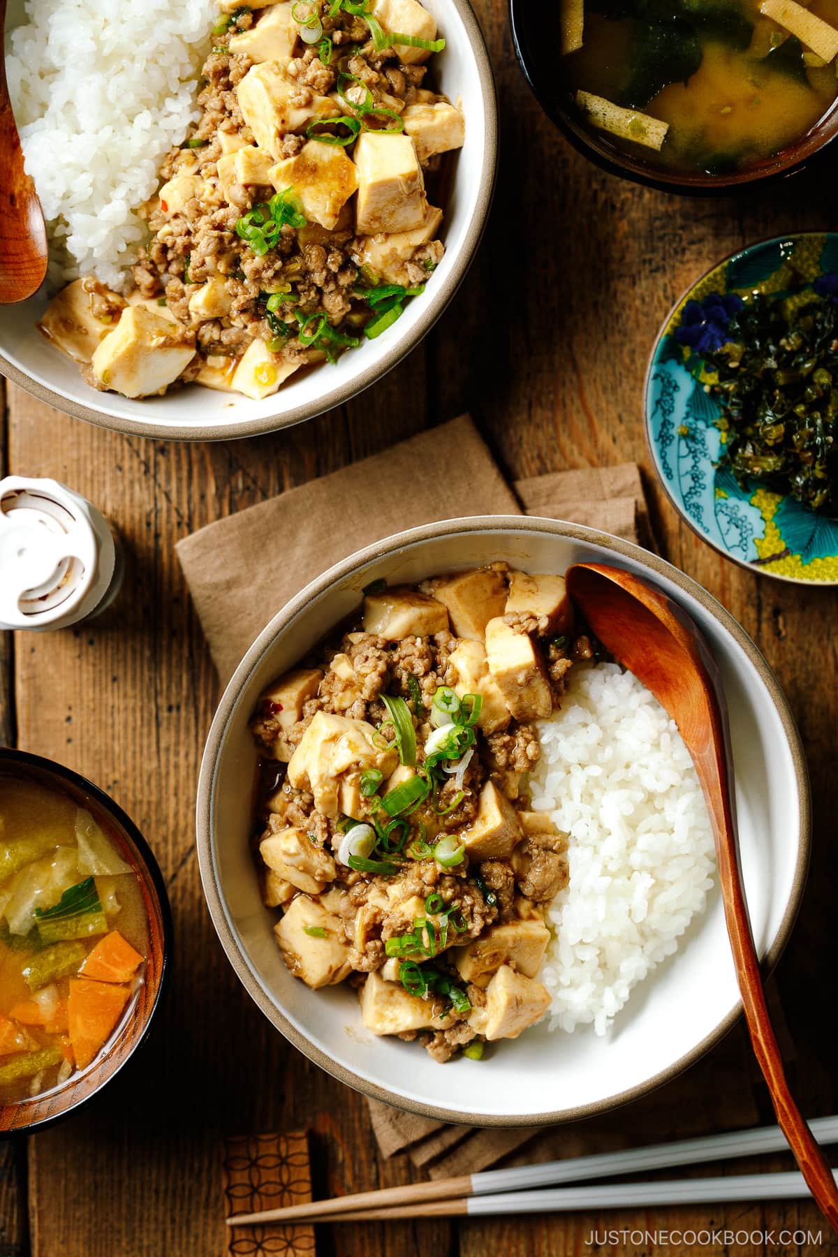 Bowls containing mapo tofu over steamed rice.