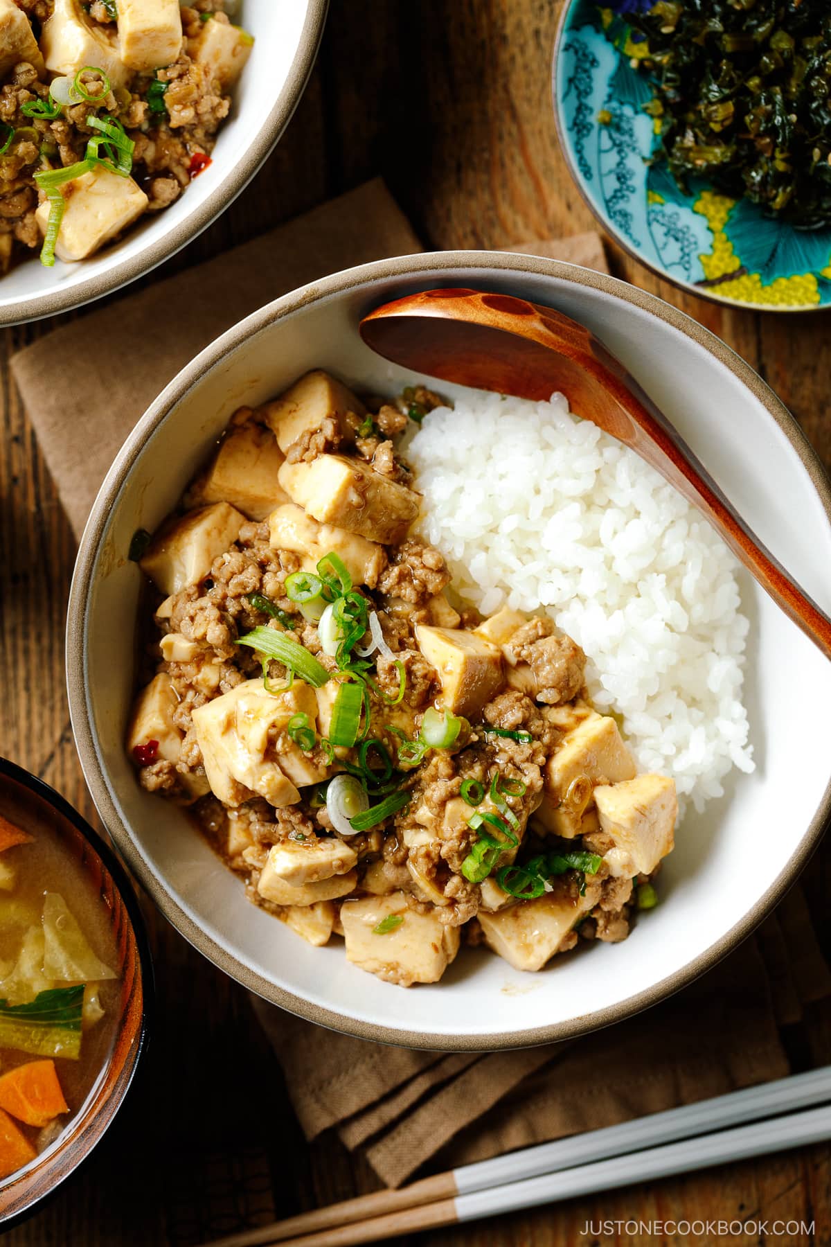 A bowl containing mapo tofu over steamed rice.