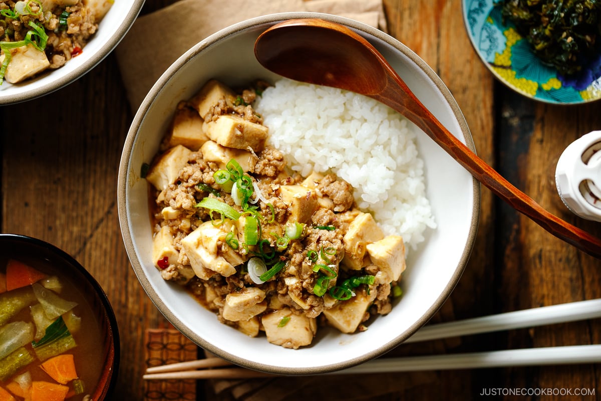 A bowl containing mapo tofu over steamed rice.