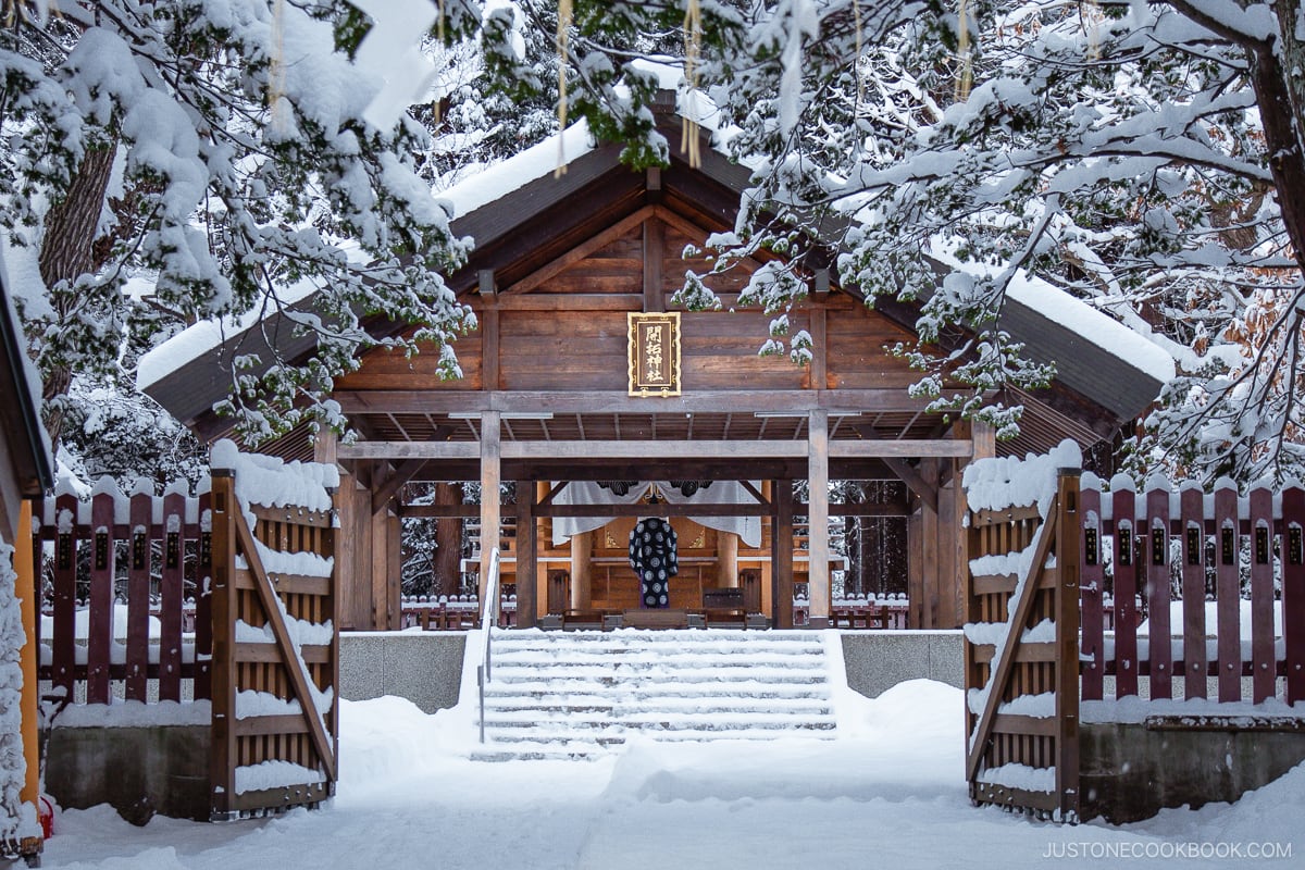 Smaller shrine in Hokkaido Jingu grounds covered in snow