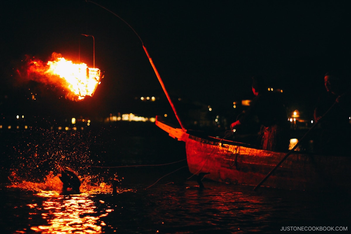 Fishing on a wooden boat at night