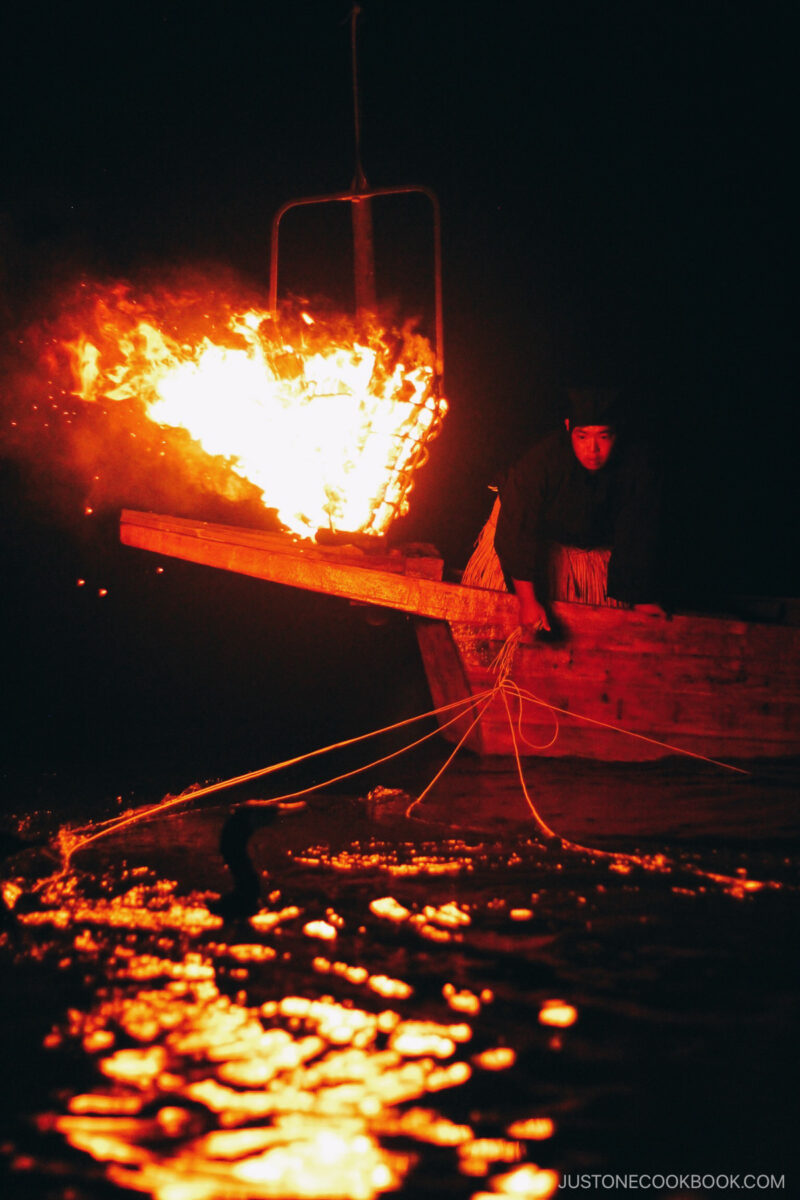 Fishing on a wooden boat at night