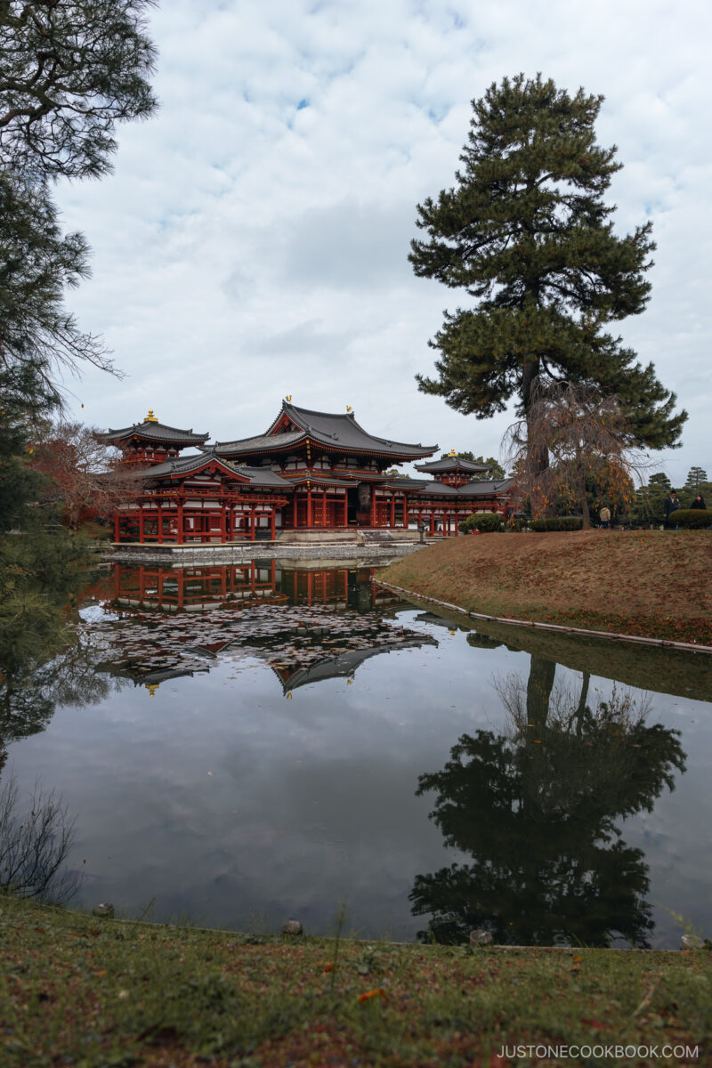 Temple surrounded by a moat and autumn leaves