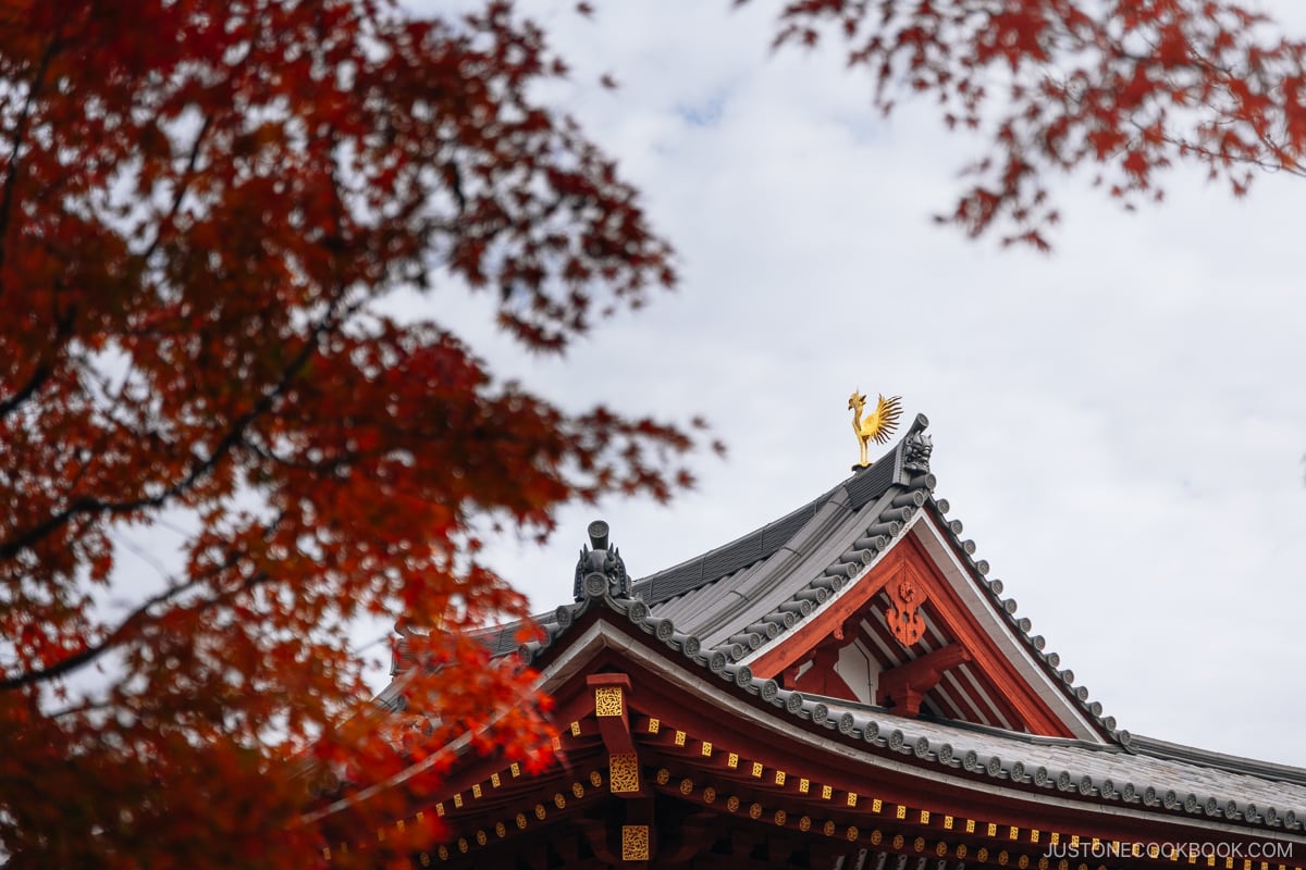 Golden pheonix statue on top of a temple roof