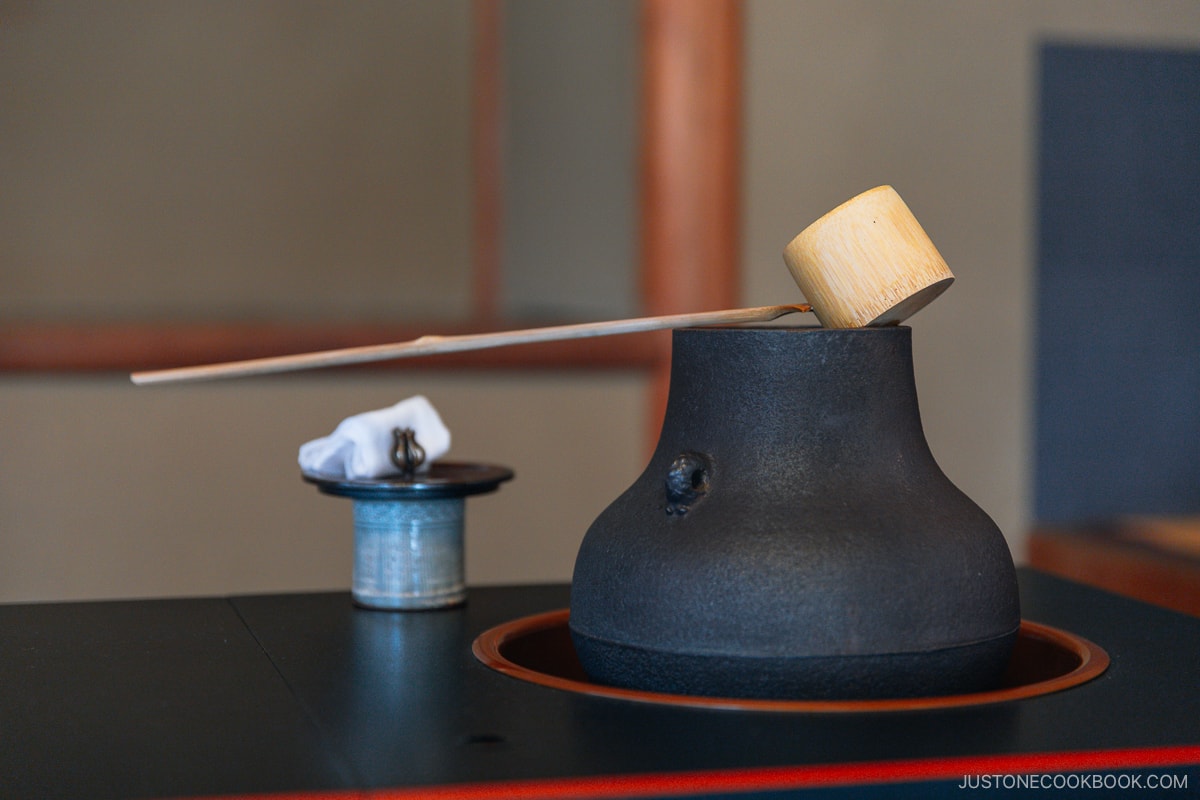 Stone pot with hot water and bamboo ladle used for matcha tea ceremony