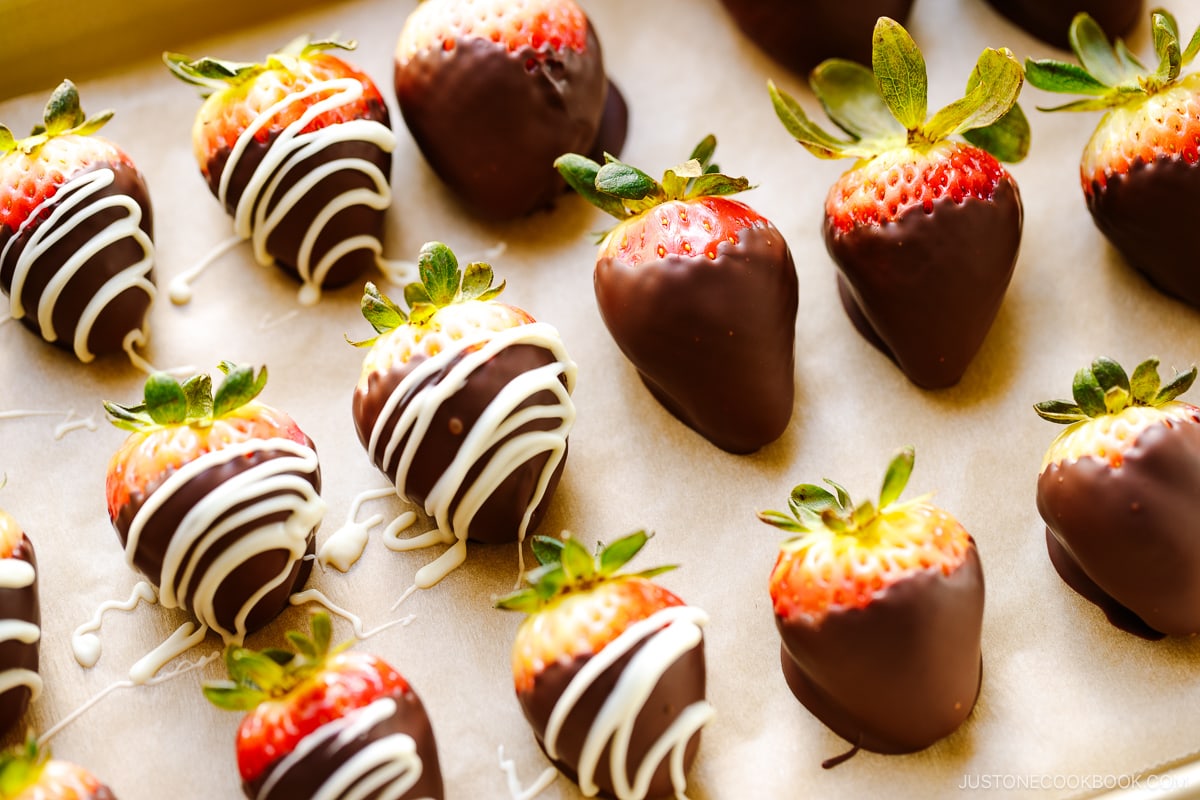 Chocolate covered strawberries on a baking sheet.